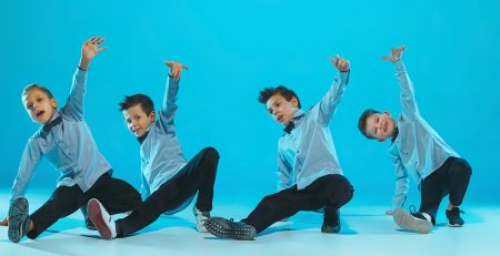 Four young boys perform a hip hop dance routine, showing their strength a benefit of taking dance classes