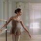 Ballerina at the ballet barre dressed in a leotard and tights