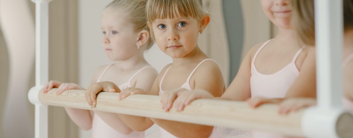 little ballerina girls at the ballet barre ready for dance class
