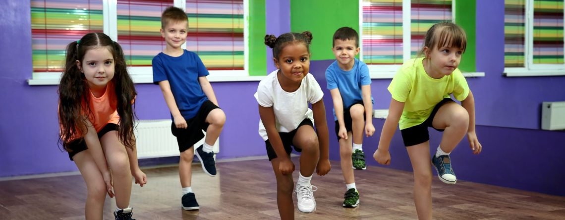 Five young dancers are having fun performing in their hip hop dance class