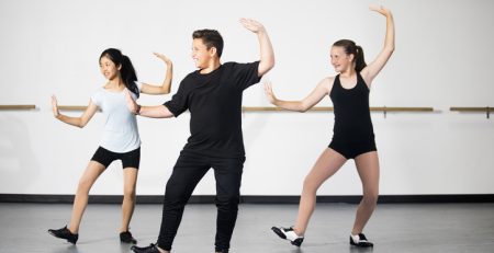 Teenage tap dancers in their local dance studio take class together